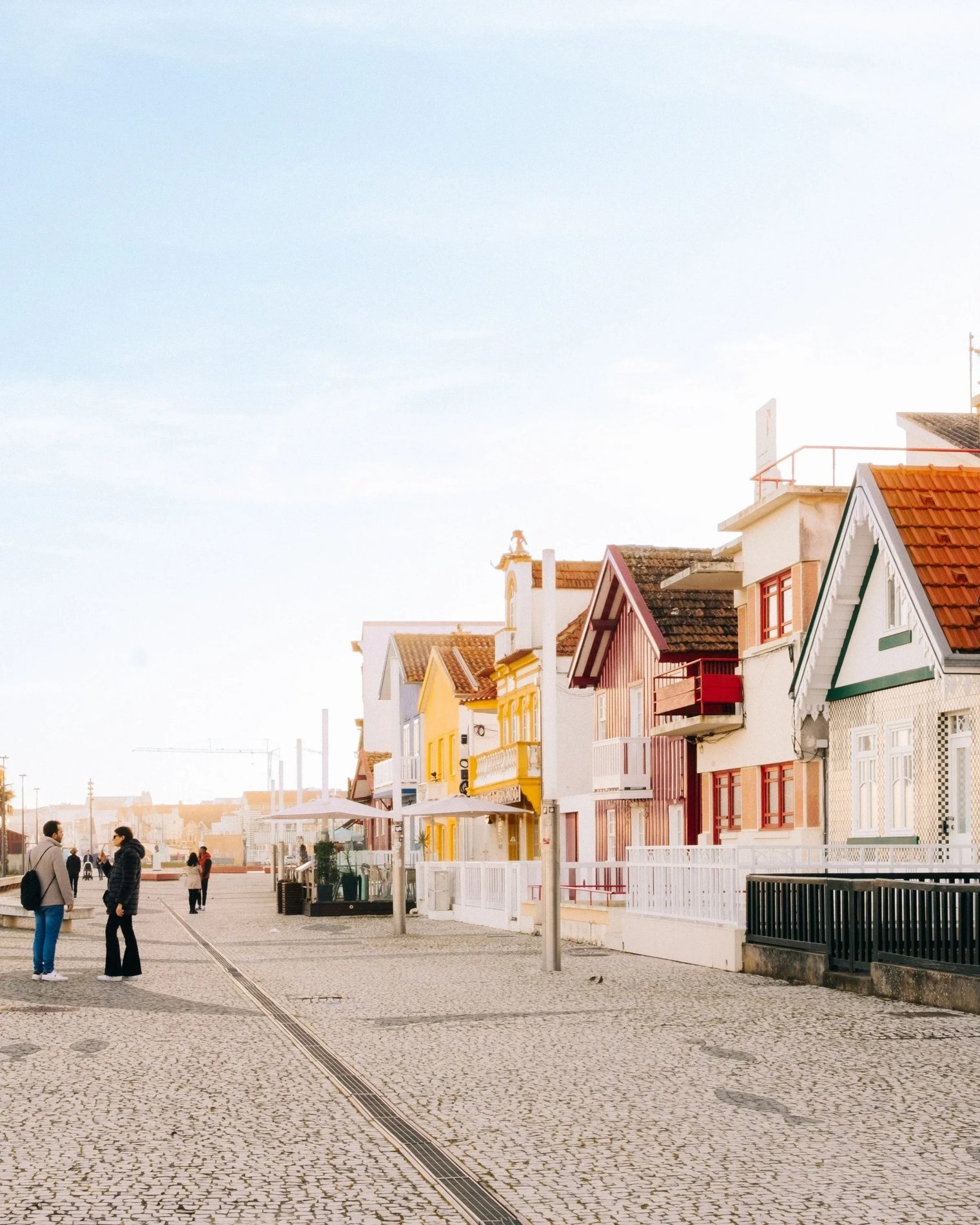 a row of colorful houses on a cobblestone street