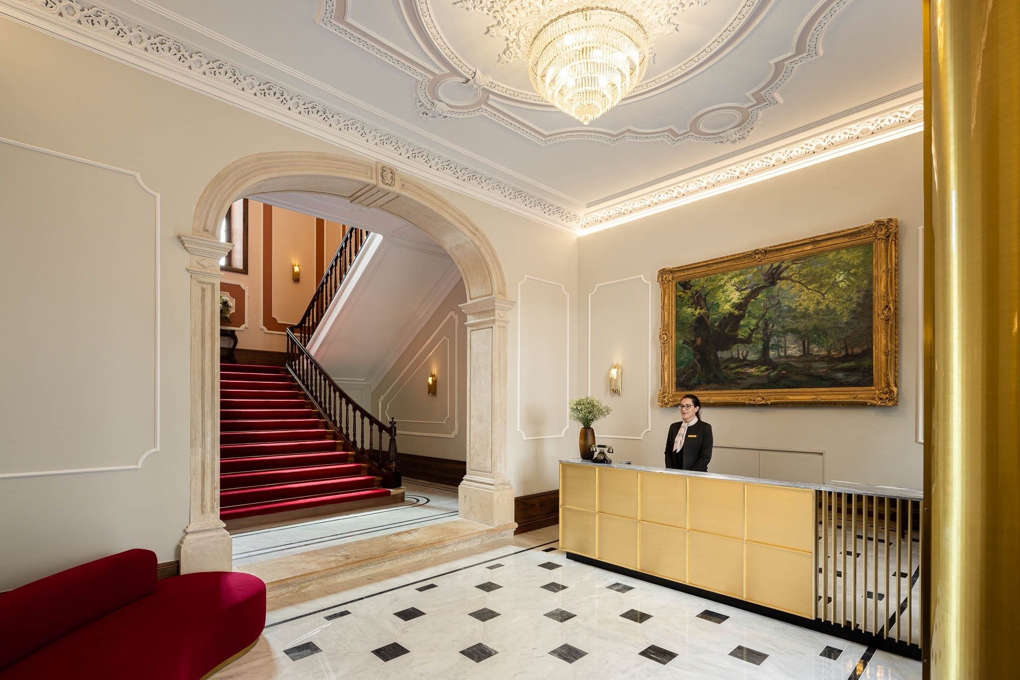 a staircase with a red carpet and a window