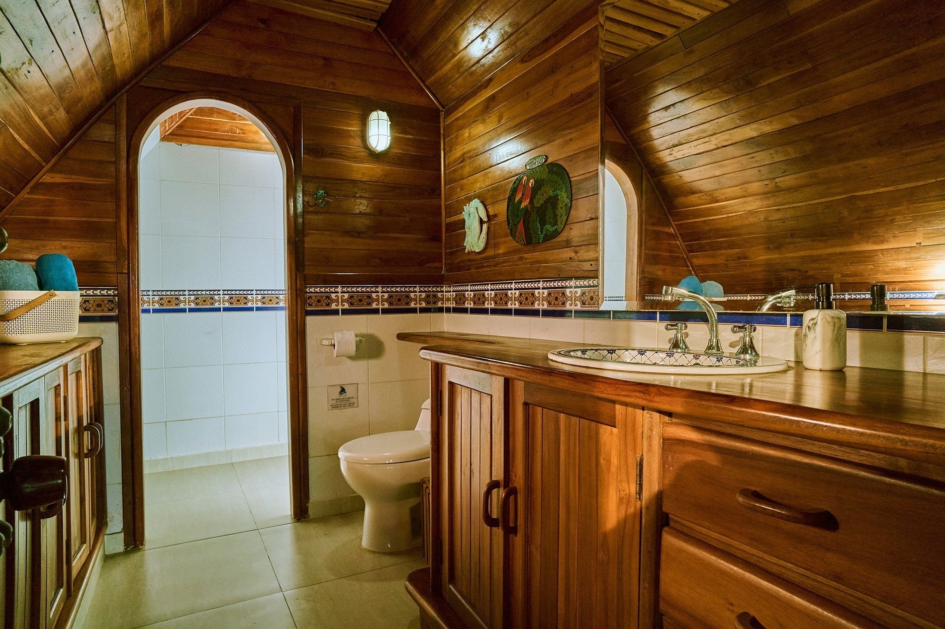 un baño de madera con un inodoro y un lavabo