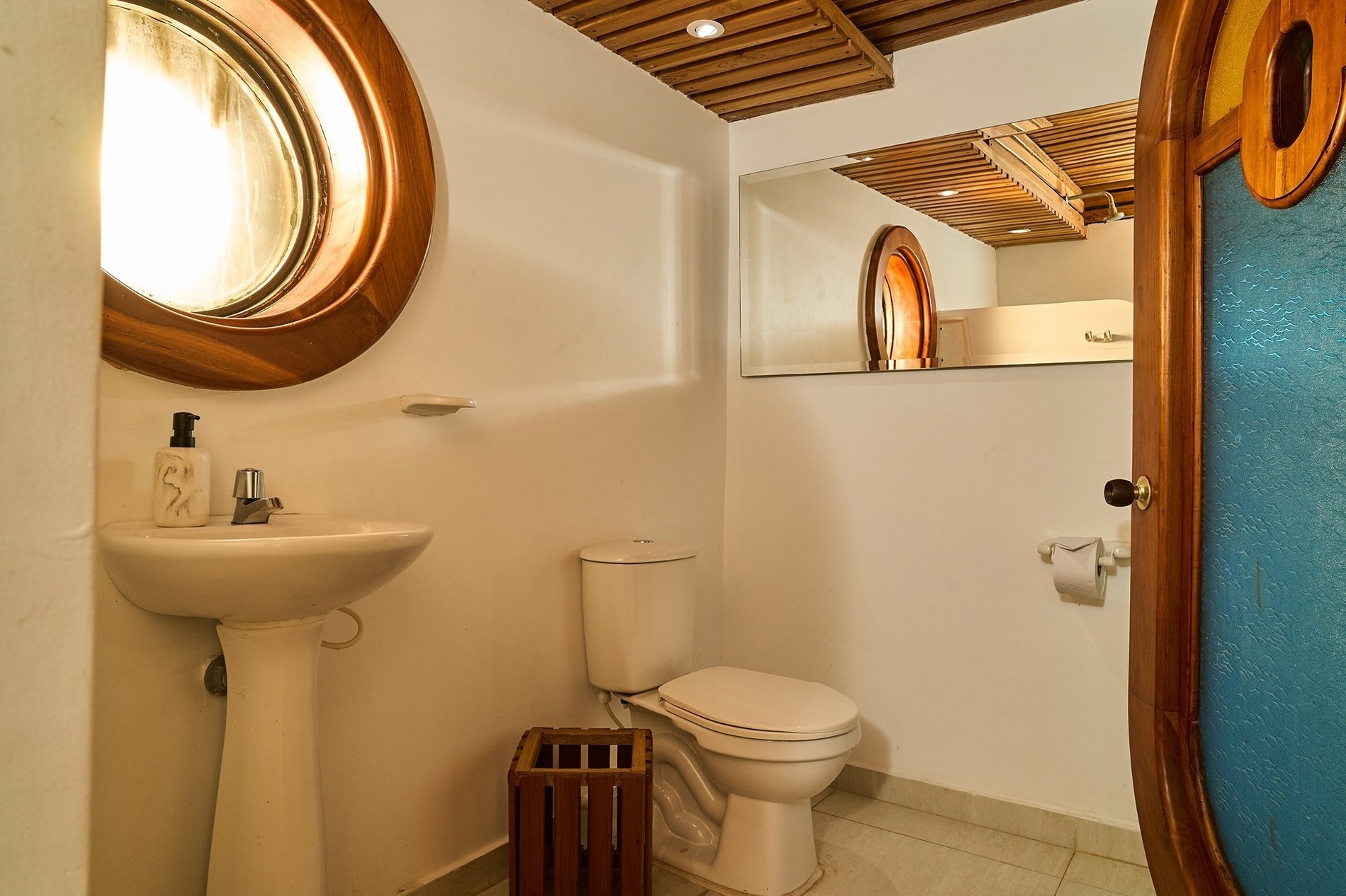 a bathroom with a toilet a sink and a mirror