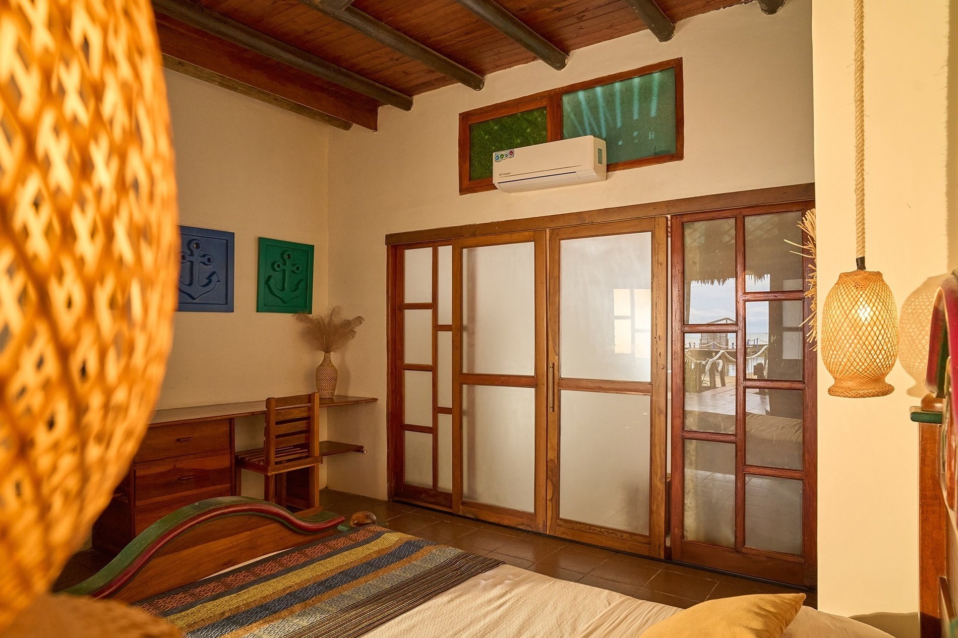 a bedroom with a sliding glass door leading to a balcony