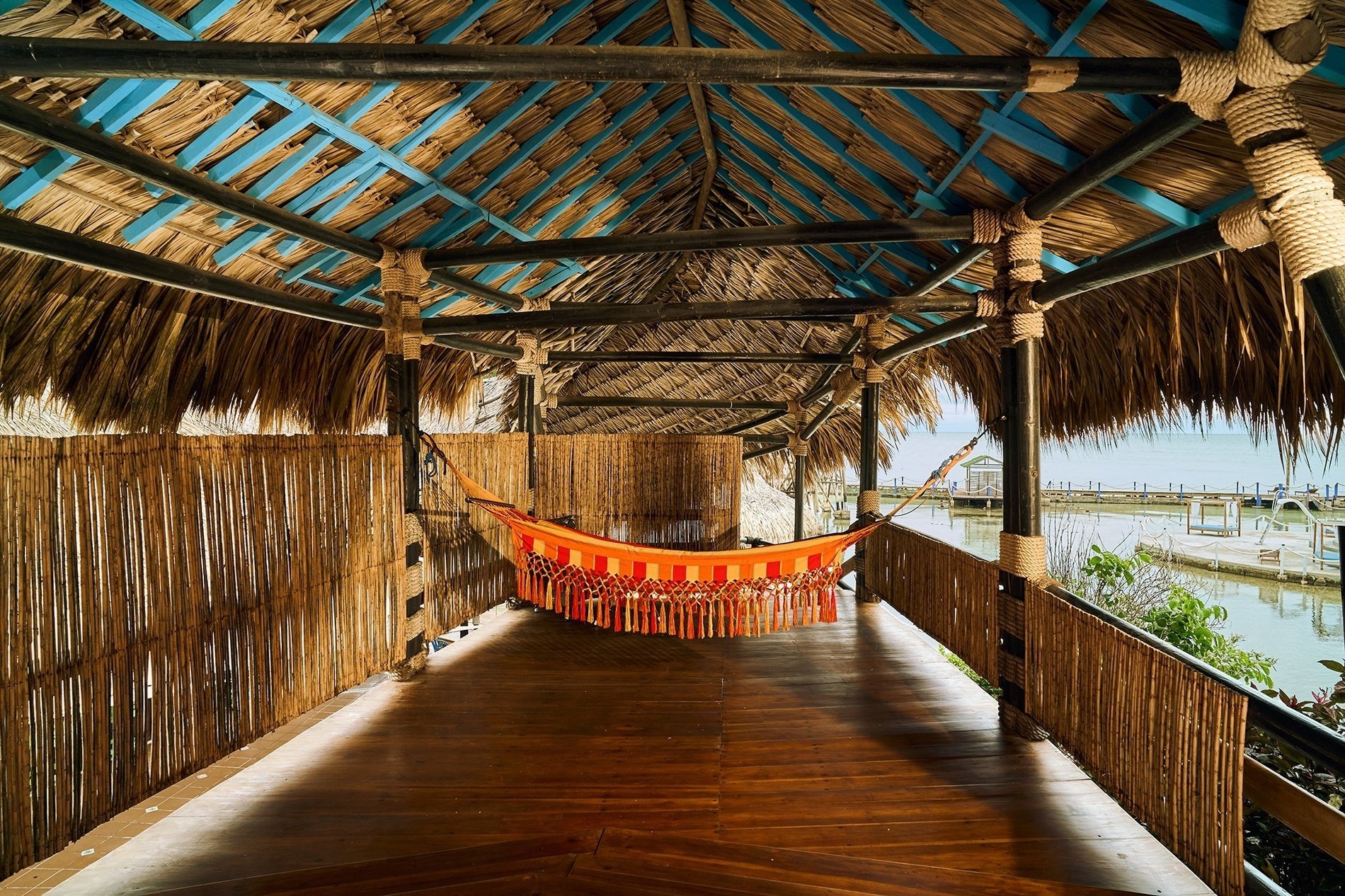 a hammock is hanging from the ceiling of a hut