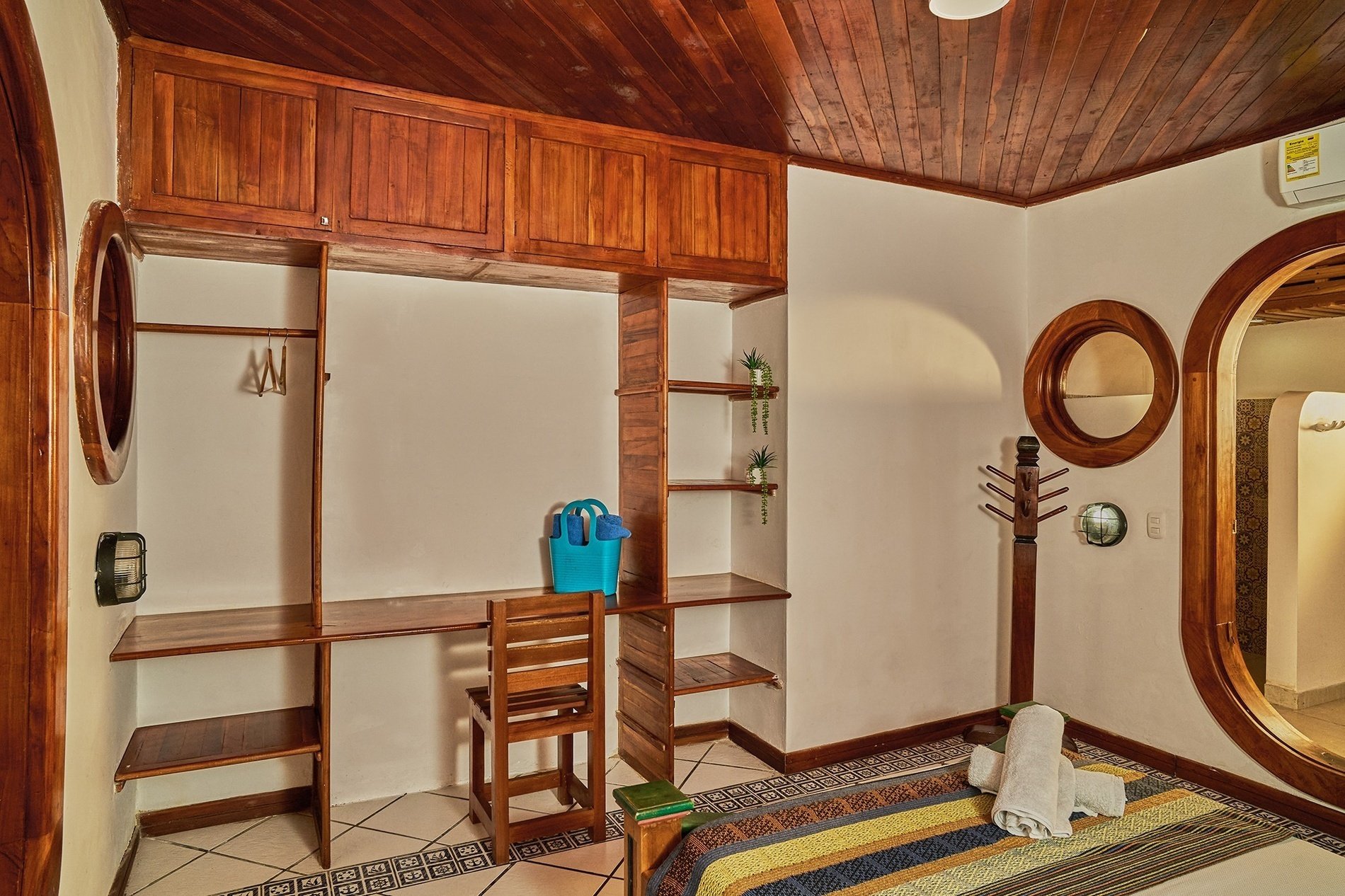 a bedroom with a blue bag on the desk