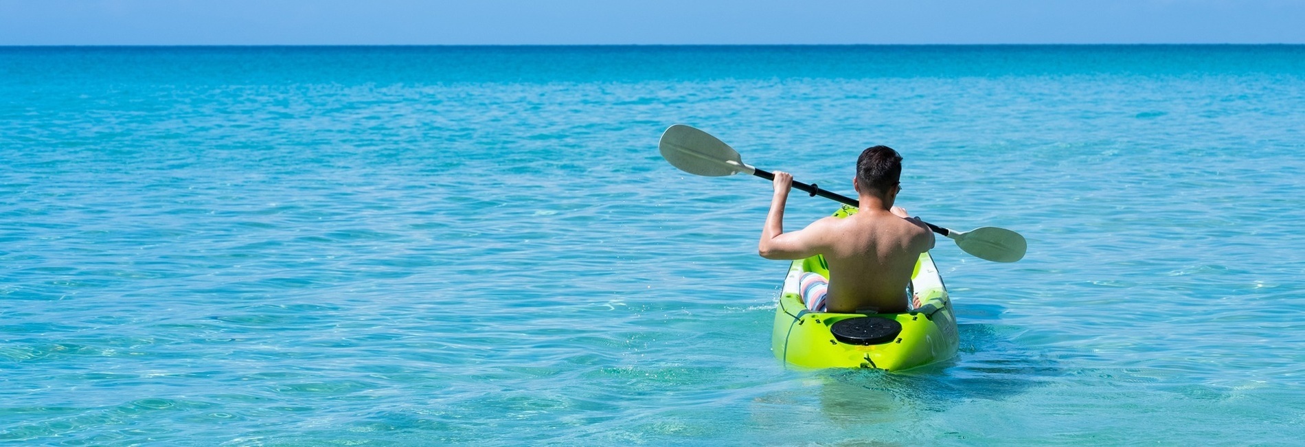 two people in a yellow kayak with the word kayak on it