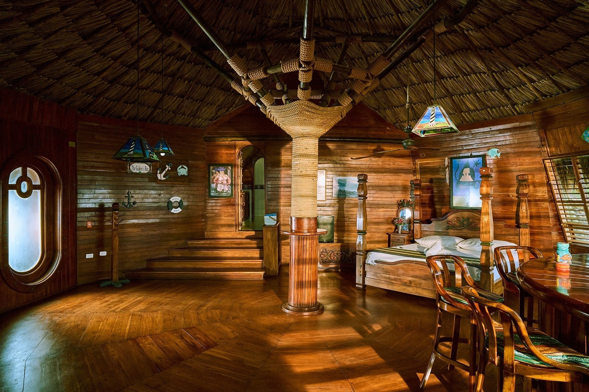 a bedroom with a thatched roof and a bed