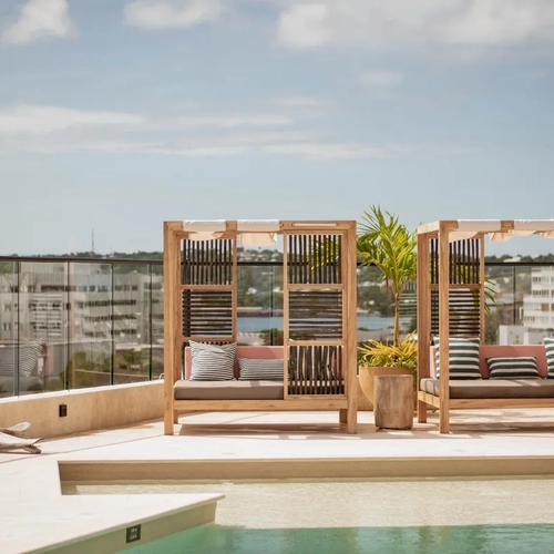 Modern rooftop lounge with cabanas and pool, perfect for Nattivo Collection Hotel.
