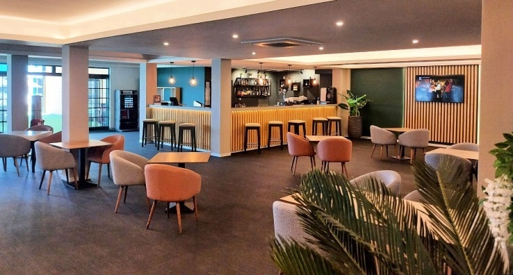 uma sala de jantar com mesas e cadeiras e um bar .