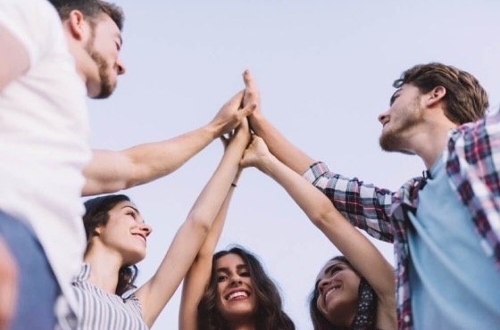 a group of people are giving each other a high five