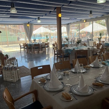 a restaurant with tables and chairs set up for a meal