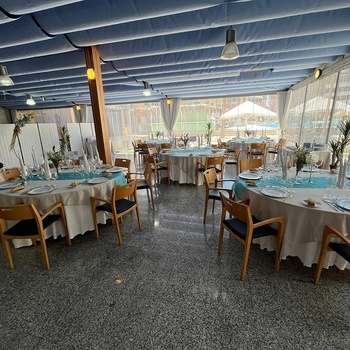 a dining room with tables and chairs set up for a wedding reception