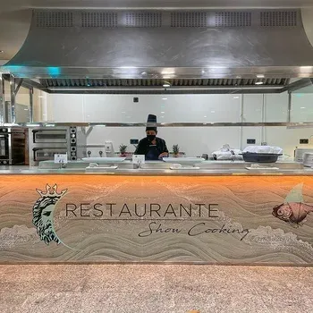 On Hotels: Neptuno's Show Cooking restaurant with chef and marine decor.