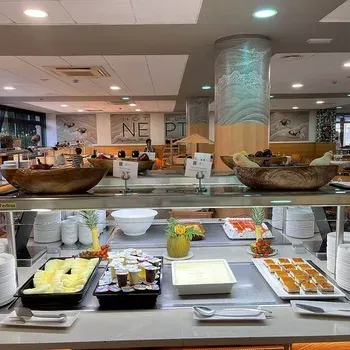 Breakfast buffet at On Hotels: Neptuno with fruit, desserts, and pastries.