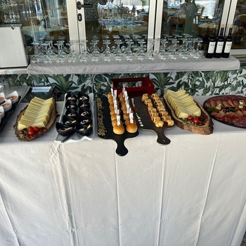 a table with a variety of food and wine bottles on it