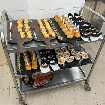 a cart filled with a variety of food including sandwiches and appetizers