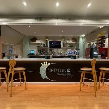 Hotel Neptuno bar area, cozy seating with marine-inspired decor.
