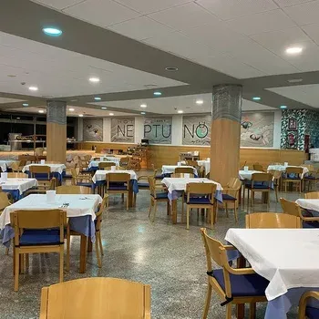 On Hotels: Neptuno restaurant, tables set for service.