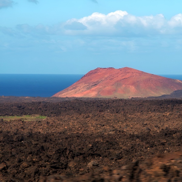 a beach scene with a bridge in the background