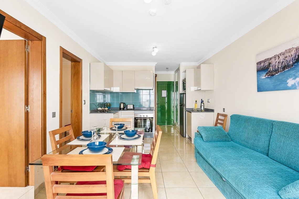 a living room with a blue couch and a table