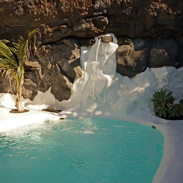 a man and a woman are standing in front of a sign that says aqualand