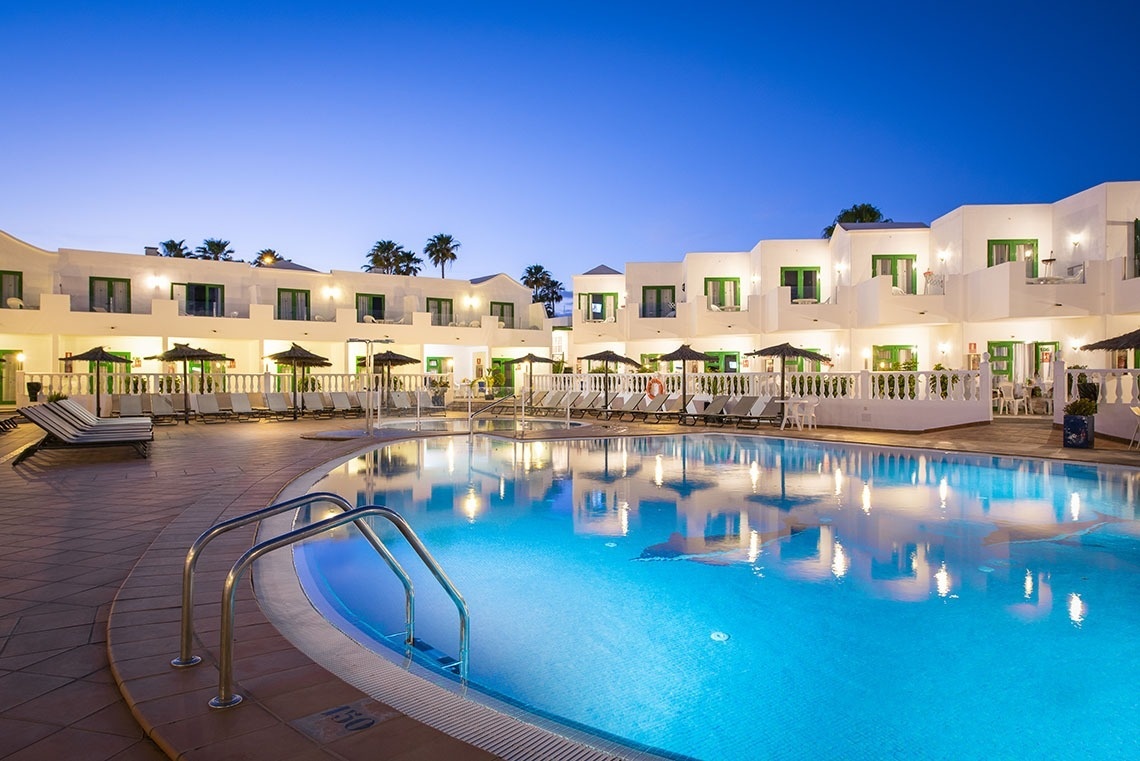 a large swimming pool in front of a hotel with the number 150 on the side