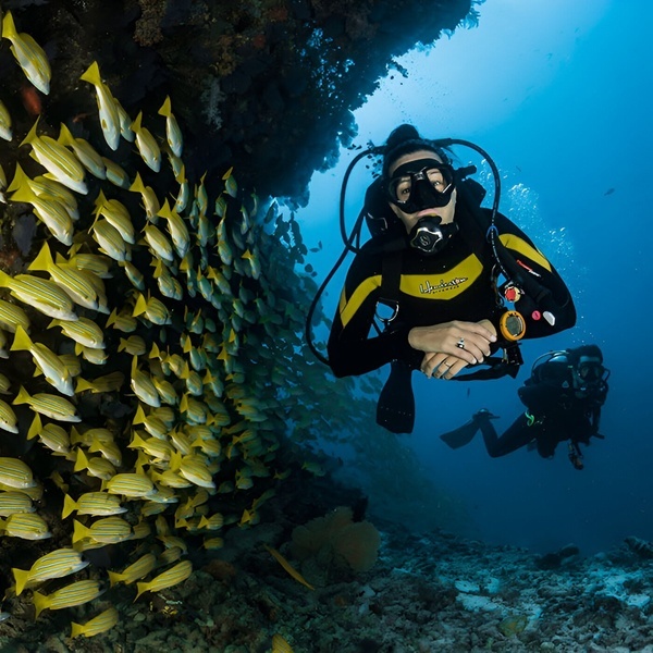 a couple of people playing golf near a lake