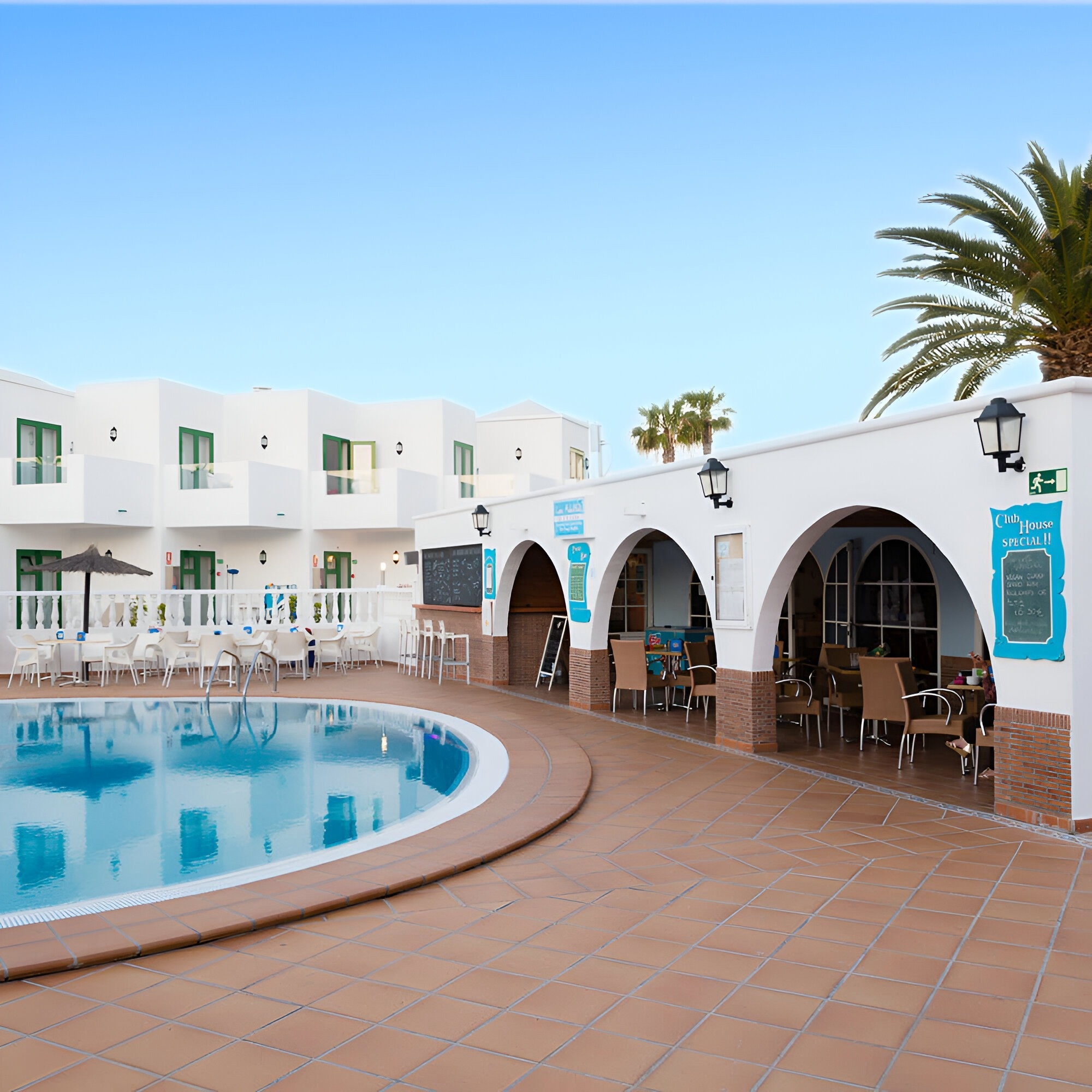 a swimming pool with a canopy bed in the foreground