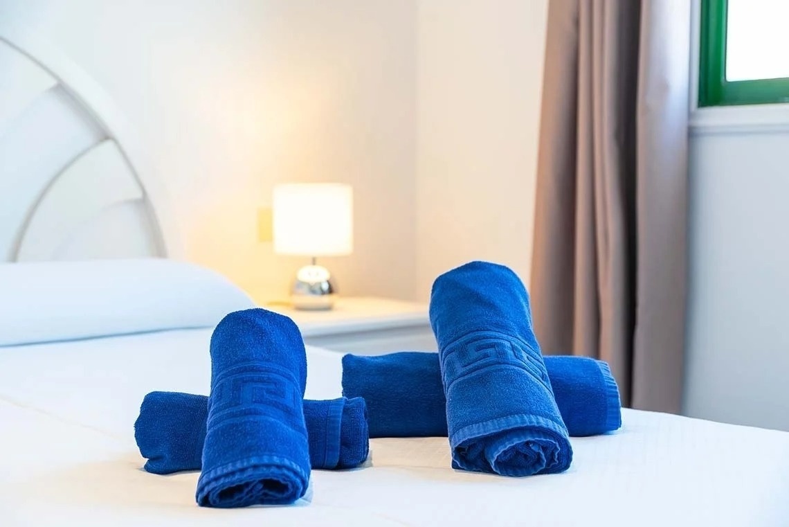 an aerial view of a row of houses with a pool in the middle