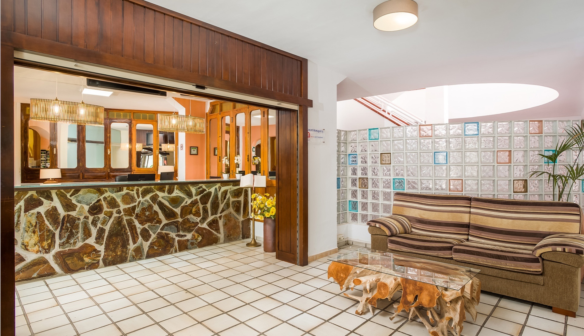 a couch sits in front of a stone counter in a room