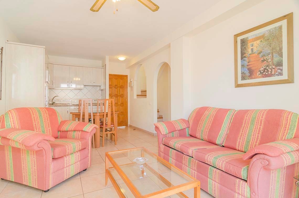 a living room with a couch and two chairs