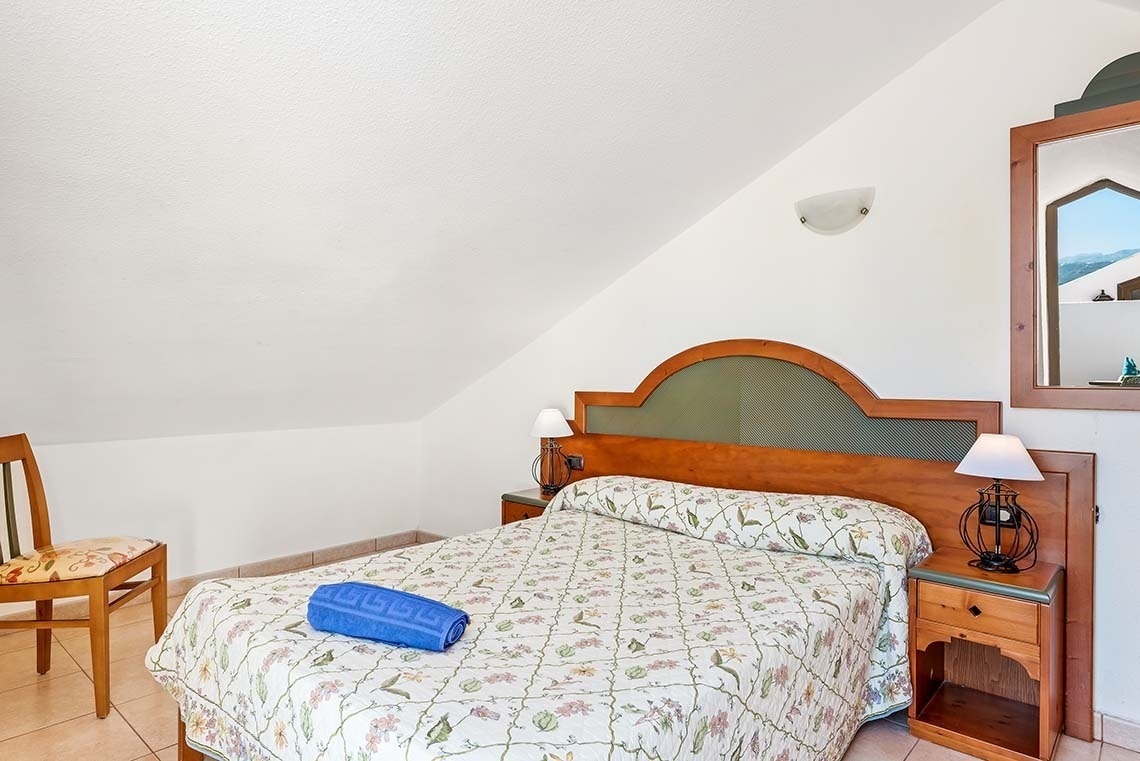 a bed with a greek key pattern on it