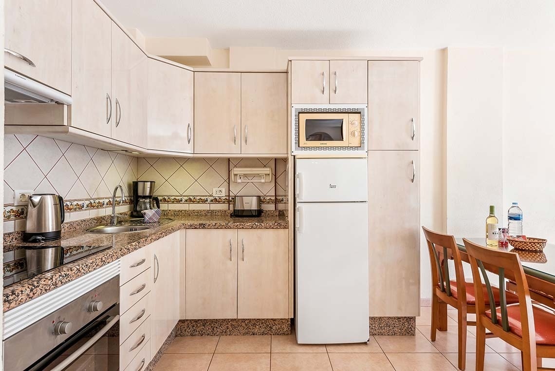a kitchen with a beko refrigerator and a microwave