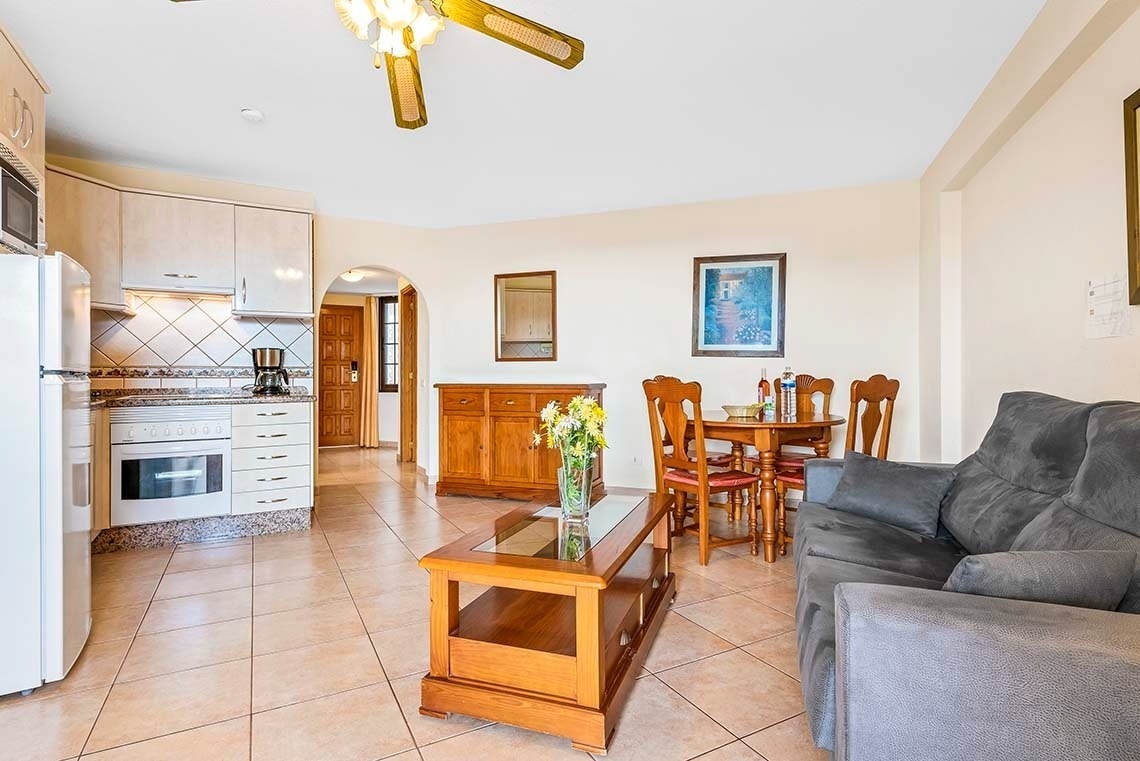 a living room with a couch a table and chairs