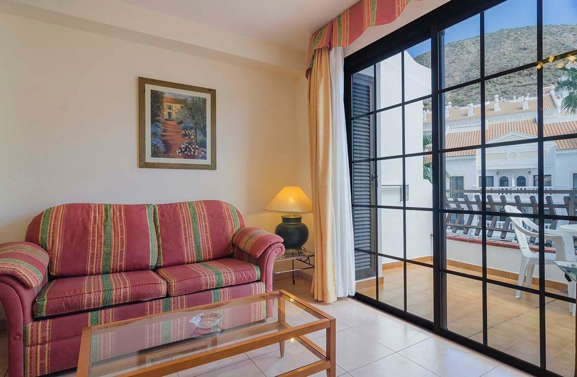 a living room with a couch and a picture on the wall