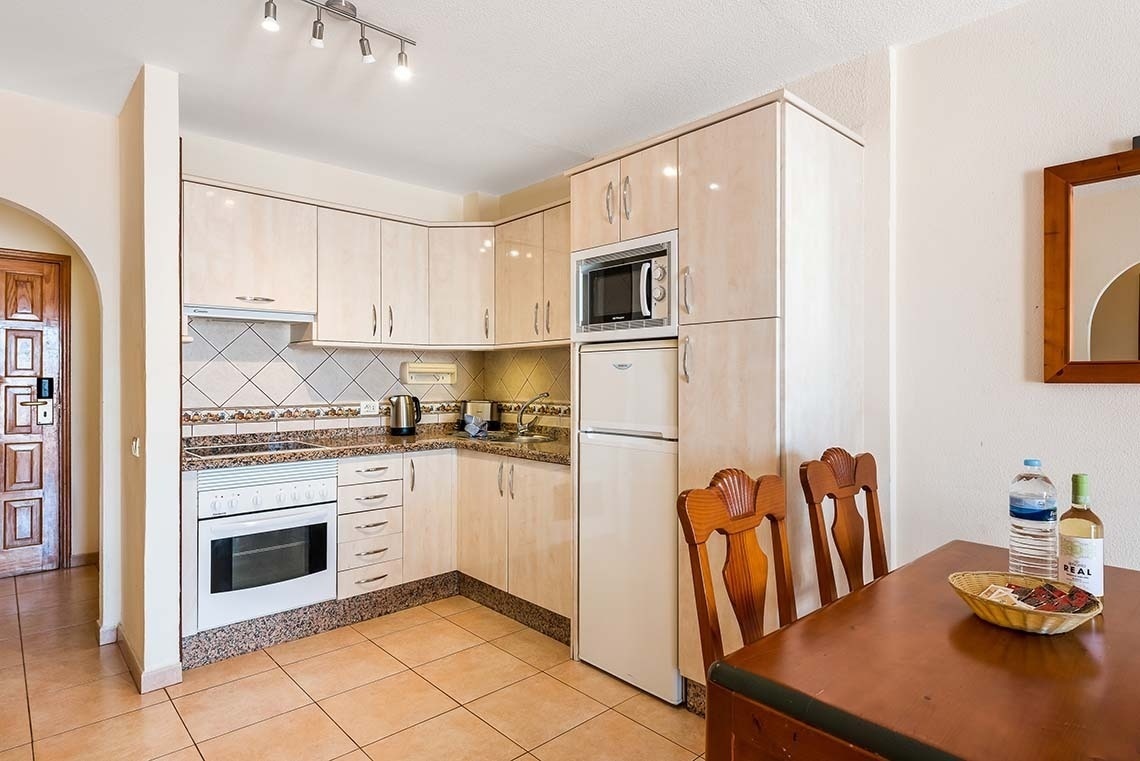 a small kitchen with a fridge and a microwave