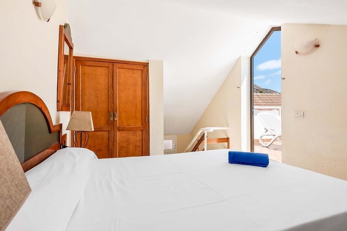 a bed with a blue towel on it in a bedroom