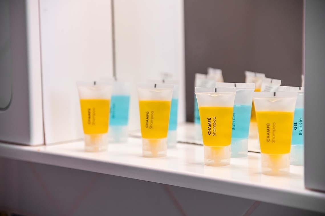 several bottles of champu shampoo sit on a counter