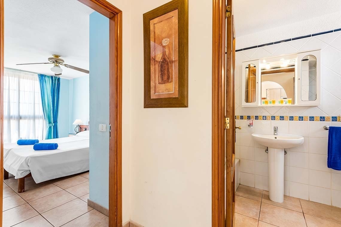 a bathroom with a sink and a painting on the wall