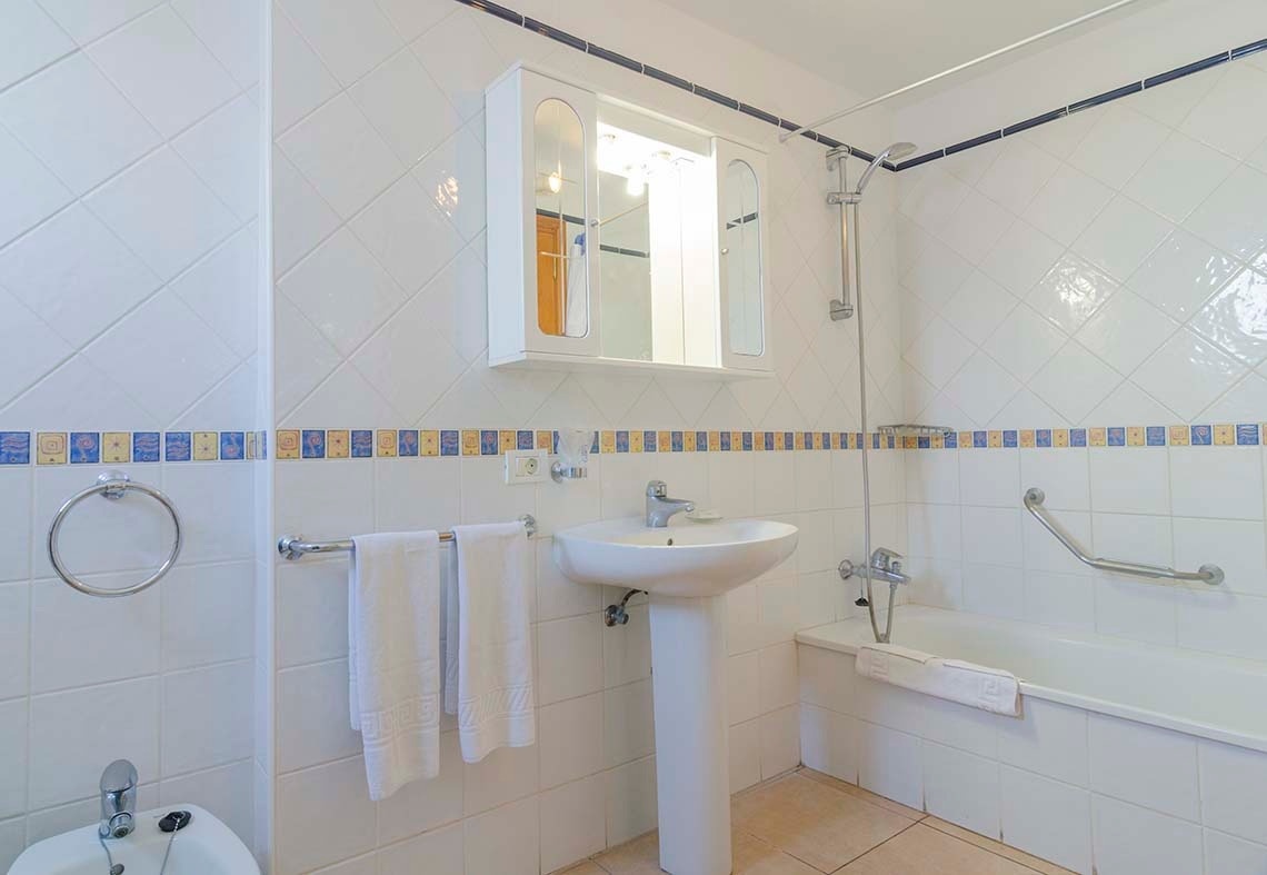 a bathroom with a pedestal sink and a bathtub