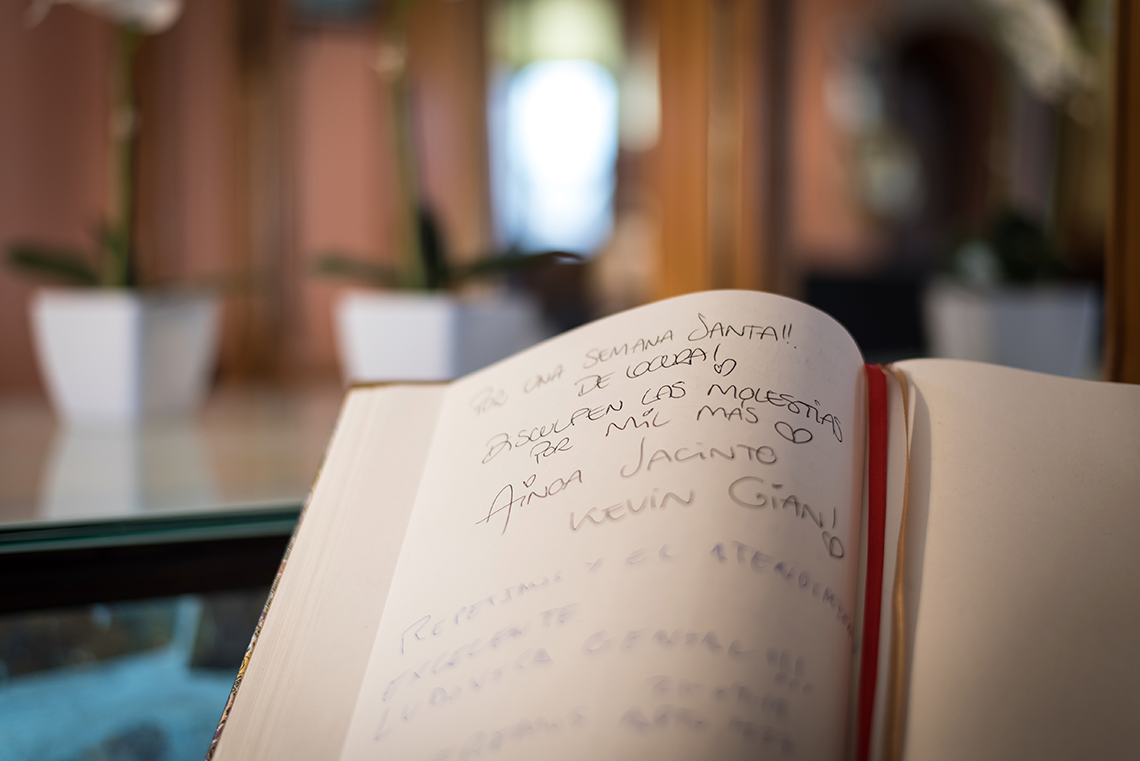 a large swimming pool with chairs and umbrellas around it
