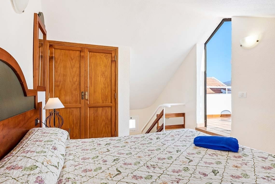 a bedroom with a bed and a blue towel on it