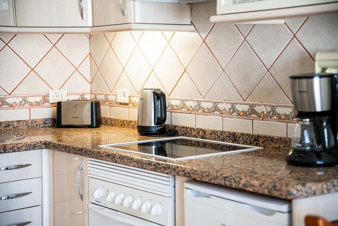 a kitchen with a stove top oven a toaster and a coffee maker