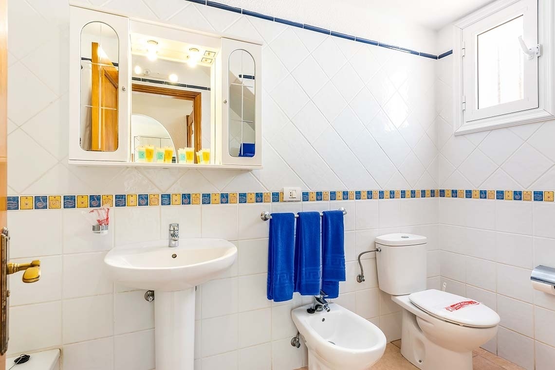 a bathroom with a sink a toilet and a bidet