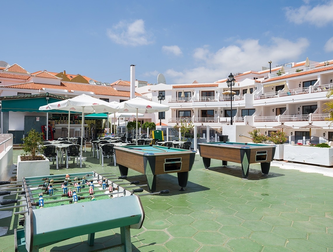 a swimming pool with a canopy bed in the foreground
