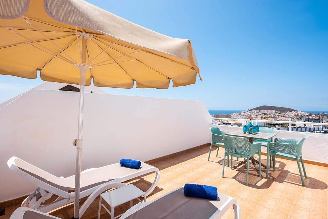 a living room with a blue couch and a picture on the wall