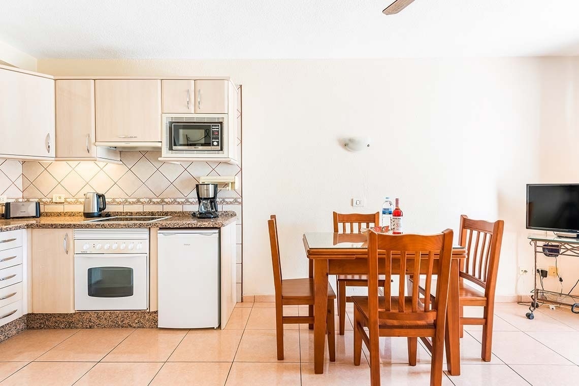 a kitchen with a table and chairs and a microwave
