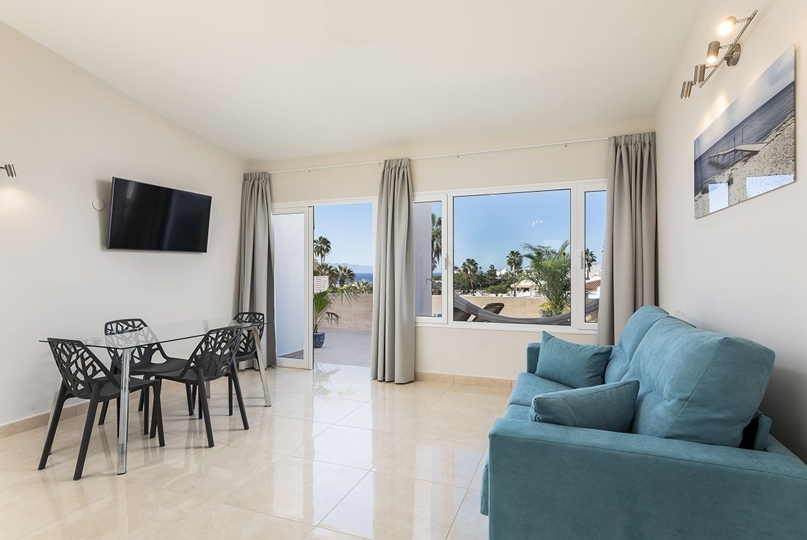 a living room with a blue couch and a flat screen tv
