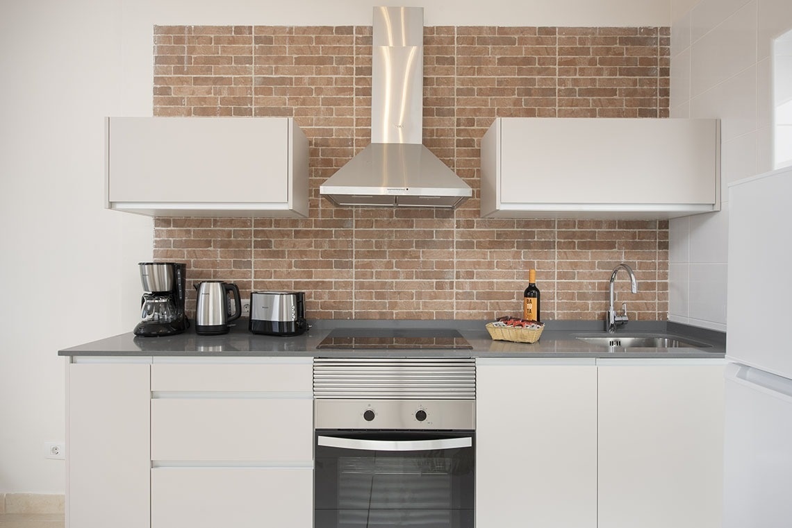 a kitchen with a bottle of wine on the counter