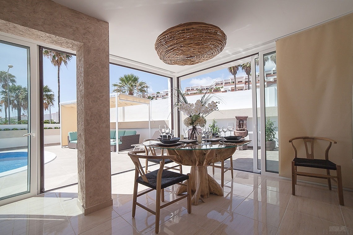 a dining room with a glass table and chairs