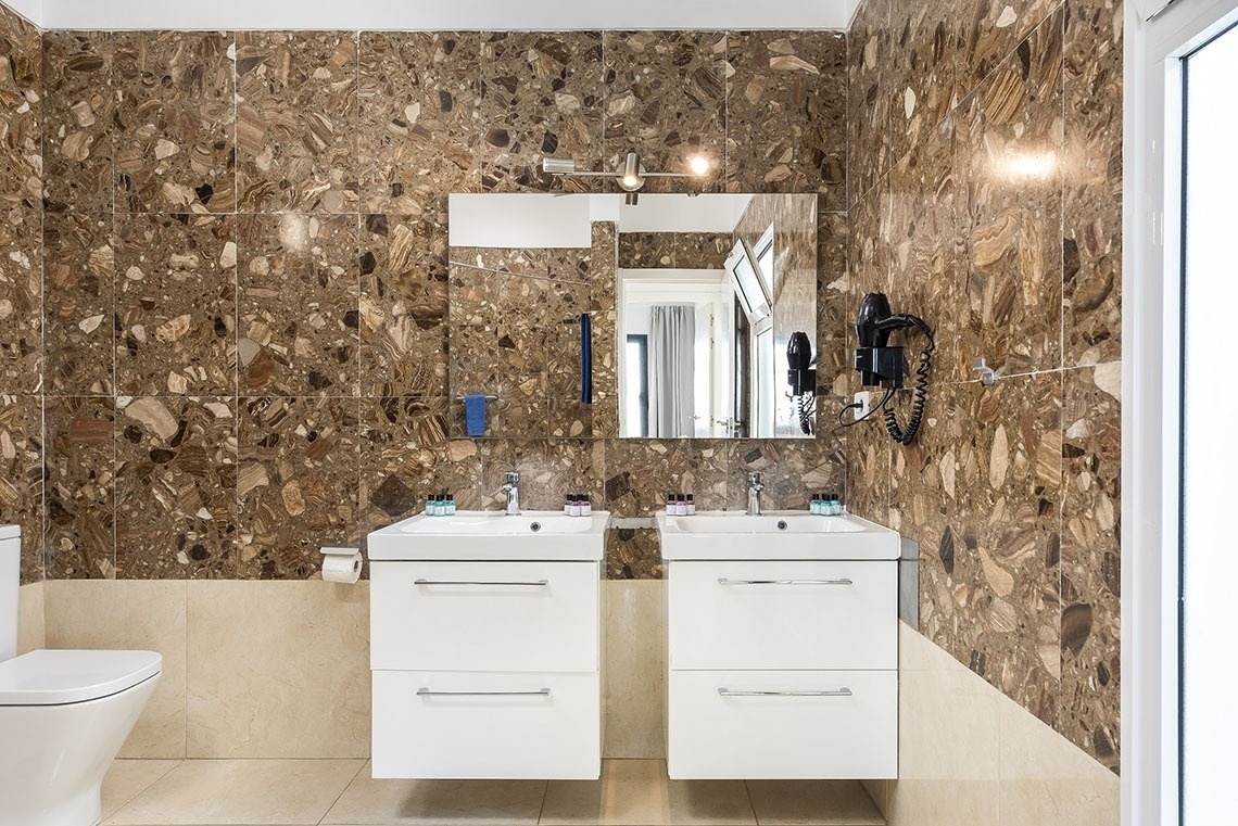 a bathroom with two sinks and a toilet