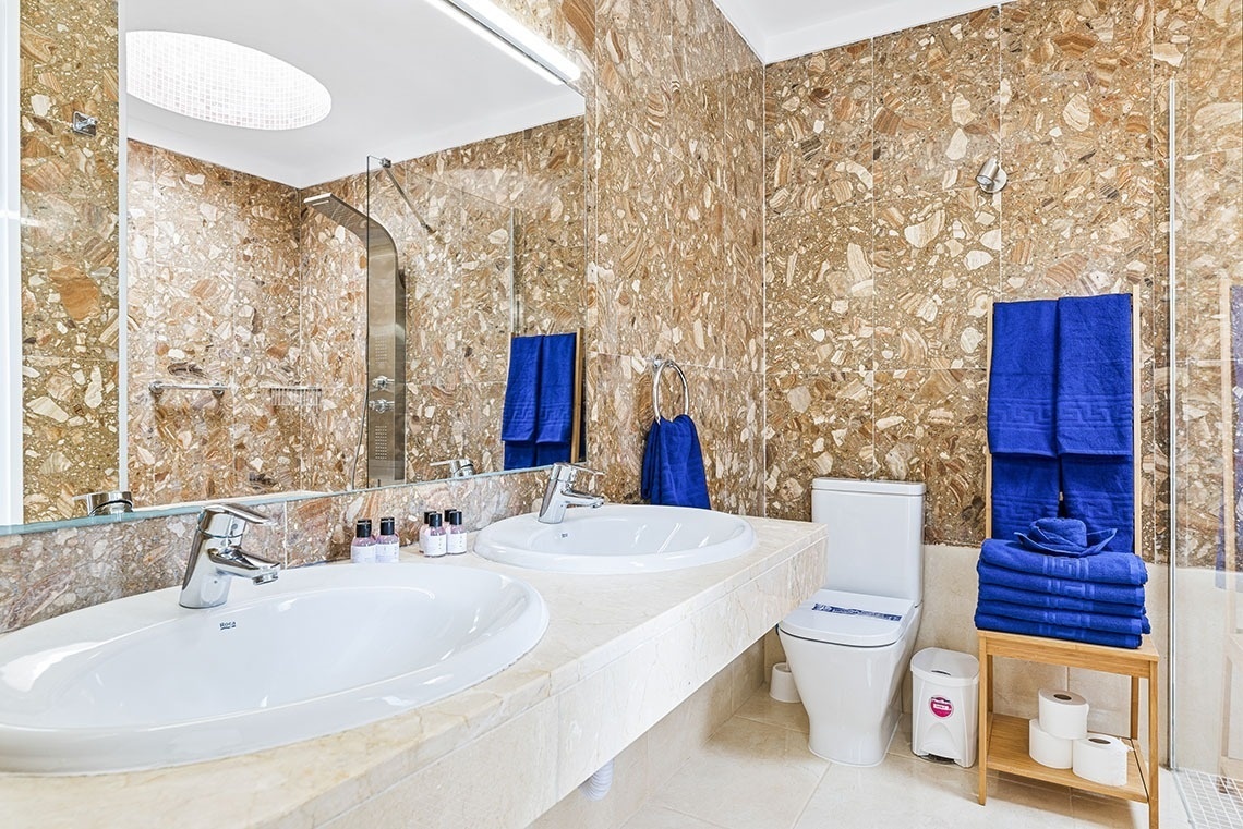 a bathroom with two sinks and a toilet